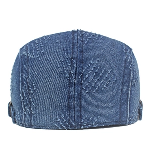 Detailed back view of distressed denim newsboy cap with vintage frayed edge finish