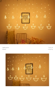 Close-up of warm white LED hanging string lights with transparent lotus shaped Diya charms