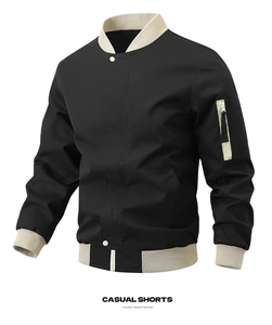 Detail of black bomber jacket featuring ribbed collar and utility zipper pocket on sleeve