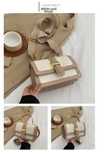 Detail of white and khaki contrast handbag featuring snakeskin texture and gold clasp