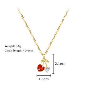 Detail view of gold cherry necklace with red heart stone and crystal pendant measurements