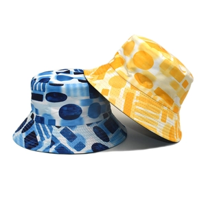 Detail of color-block bucket hats with artistic geometric patterns and premium fabric