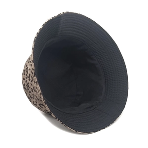 Detail shot of leopard print corduroy bucket hat showing reversible black inner lining