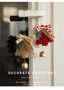 Detail of plush Christmas tree bell pendants in red and brown with Merry Christmas tags