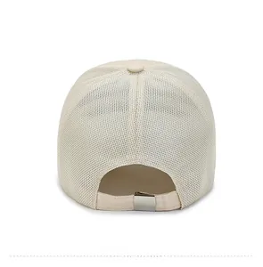 Detail of breathable mesh back on beige baseball cap with adjustable silver metal buckle