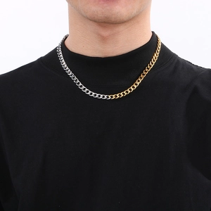 Close-up of hip hop two-tone silver and gold stainless steel Cuban chain necklace