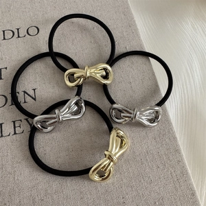 Set of 4 high-elastic hair ties with gold and silver 3D metal bowknot ornaments