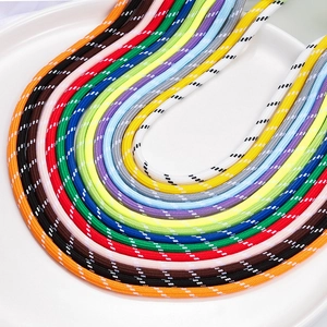 Vibrant 5mm braided nylon cords in various colors for DIY crafts on a white tray