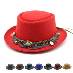 Detail of red wool felt fedora featuring ethnic style beadwork and turquoise accents