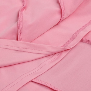 Close-up of pink fabric texture and high-quality stitching on a slim-fit summer dress