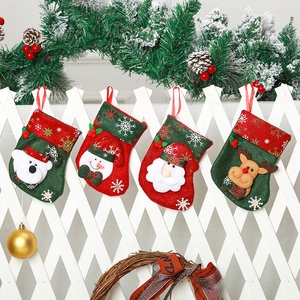 Detail of four festive Christmas stockings with Santa, Snowman, Bear, and Reindeer motifs