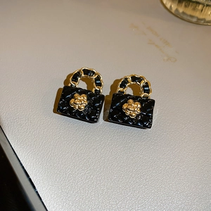 Detailaufnahme der Blumen-Handtaschen-Ohrringe mit schwarzer Emaille und Kamelienmotiv