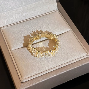 Macro view of gold plated eternity ring featuring rectangular cut cubic zirconia stones