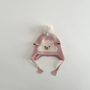 Detailed knit texture of pink toddler winter hat with plush pom-poms and ear flaps