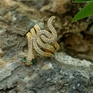 Snake wrap open ring in 18K gold plating with pave zircon and green gem eyes on rock