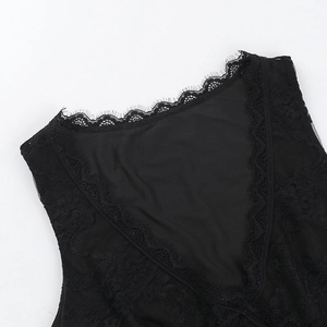 Macro detail of the elegant black lace V-neckline on a stylish slim-fit crop top for women