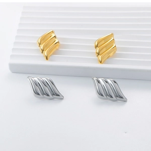 Detailed macro view of 18K gold plated earrings with irregular wave texture
