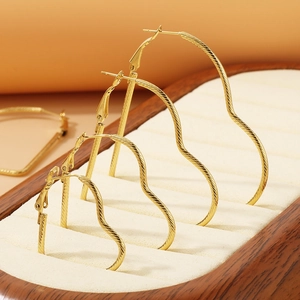 Golden heart-shaped hoop earrings with textured finish in four different sizes