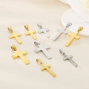 Flat lay of polished gold and silver cross pendants in various sizes and textures