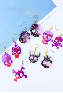 Macro shot of various skull earring resin charms made from a DIY silicone mold