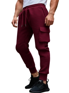 Detail of burgundy waffle knit jogger pants featuring drawstring waist and cargo pocket
