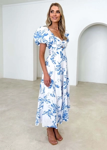 Detailed view of puff sleeves and waist cutout design on floral maxi dress