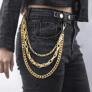 Close-up of triple-layered gold metal pants chain with spring hooks on black denim jeans