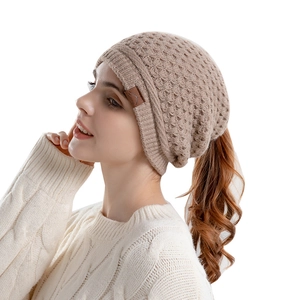 Winter warm knitted ponytail beanie for women in beige with a functional top opening