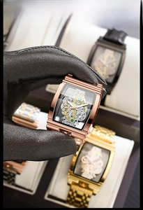 Close-up of skeleton mechanical watch movement with rose gold barrel-shaped case