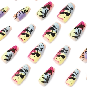 Graffiti style press-on nails with heart, skull and colorful leaf patterns on white background