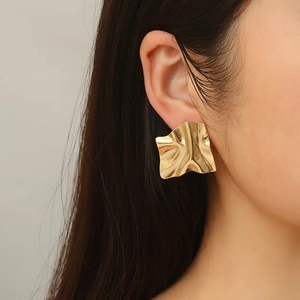 Close-up of model wearing irregular gold-plated stainless steel earrings in French style