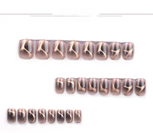 Detail view of 24pcs coffee brown press-on nails with gold glitter and marble gradient