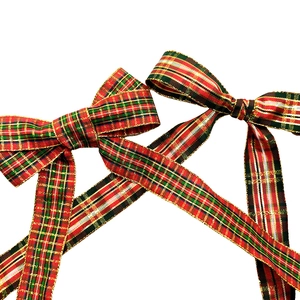 Macro view of handmade Christmas plaid bows with red and green festive ribbons
