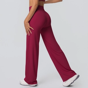 Detail of high-waist burgundy yoga pants showing the hip curve and flowy wide-leg cut