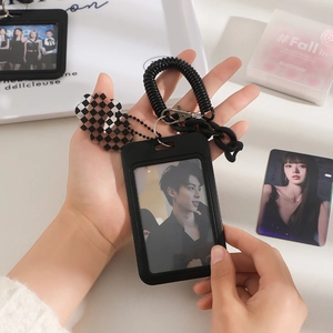 Detail of black minimalist card holder with spring lanyard and cloud acrylic charm