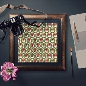 Close-up of vintage Christmas wreath pattern scrapbook paper with retro camera accents