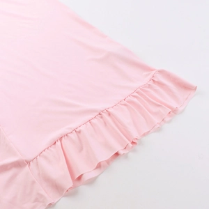 Macro shot of delicate pink ruffle hem stitching on a sexy V-neck summer slit dress