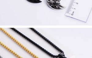 Macro detail of crescent moon pendants with flame patterns and colorful ball chains