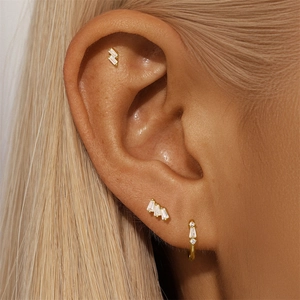 Close-up of S925 silver gold-plated hoop earrings with white zircon on a female model