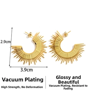 Detail of gold crescent sun earrings with hammered texture and 2.9cm by 3.9cm dimensions