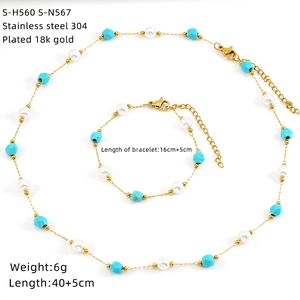 Macro detail of 18K gold-plated stainless steel jewelry set with pearls and blue stones