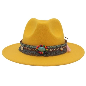 Detailed view of yellow wide-brim cowboy hat with colorful beads, tassels and turquoise band