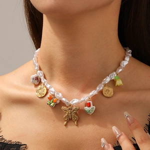 Baroque pearl necklace with floral ceramic butterfly and heart heart charms on model