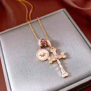 Collana placcata oro 18k con croce di zirconi, gemma viola e pendente a sole