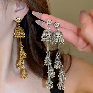 Detailed close-up of ethnic Jhumka fringe earrings with metallic bells in gold and silver