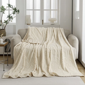Thick cream flannel blanket featuring 3D butterfly embossed pattern on a cozy sofa