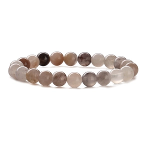 Detail of 8mm natural stone beads on elastic bracelet with brown and cream textures