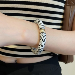 Detail of leopard print beaded bracelet with gold accent bead on wrist
