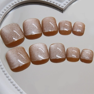 Sparkling cat-eye press-on toenails in golden sand nude brown with magnetic glitter