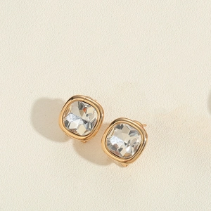 Detail of square-cut clear crystals set in 14K gold-plated minimalist vintage earrings